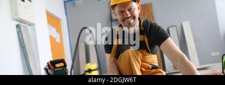Man builder holds laminate board in his hands Stock Photo