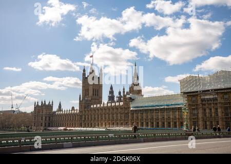 LONDON, UK - March 25, 2019: Renovation scaffolding construction with the house of parliament in view from the Westminster bridge Stock Photo