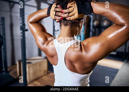 Female bodybuilder doing an arm stretching exercise Stock Photo