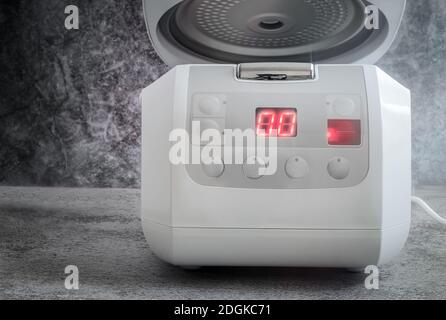 Modern electric multi cooker on the kitchen table Stock Photo Alamy