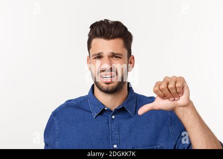 Close up portrait of disappointed stressed bearded young man in shirt over white background. Stock Photo