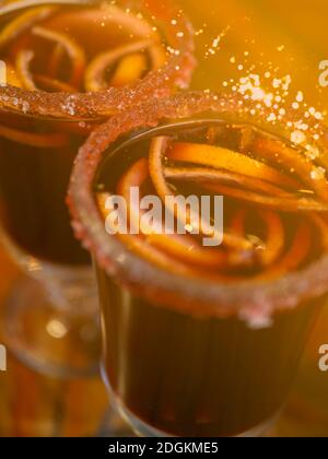 Christmas hot mulled wine in glass with cinnamon, orange slices on retro background, soft focus Stock Photo