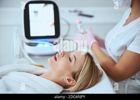 Female patient relaxing before the skin treatment Stock Photo