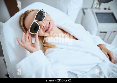 Joyful female patient relaxing before the procedure Stock Photo
