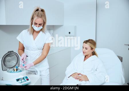 Focused doctor getting ready for a platelet-rich plasma injection Stock Photo