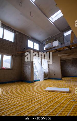 Yellow underfloor heating installation with white pipes Stock Photo