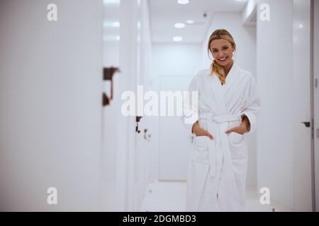 Merry pretty female spa client standing in the hall Stock Photo