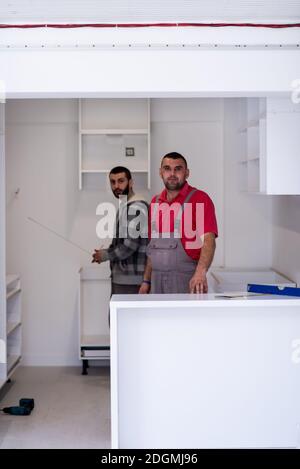 Workers installing a new kitchen Stock Photo