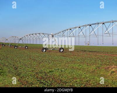 Irrigation system on wheels on the field Stock Photo
