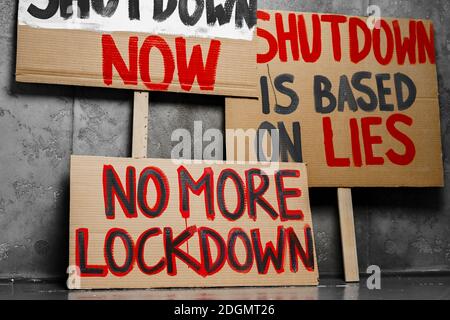 Protestive placard against coronavirus lockdowns against wall Stock Photo