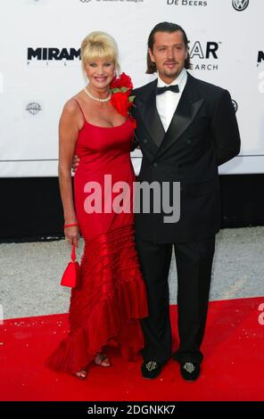 Ivana Trump and partner Rossano Rubicondi at the 10th International fundraising amfAR Cinema Against Aids benefit at Le Moulin de Mougins in Cannes. full length.red dress. red bag.  Â©doug peters/allaction.co.uk Stock Photo