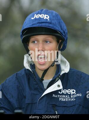 Zara Phillips and a mechanical horse that will give inner city children the chance to feel what its like to ride a horse in Hyde Park In London. Headshot. riding hat. funny  Stock Photo