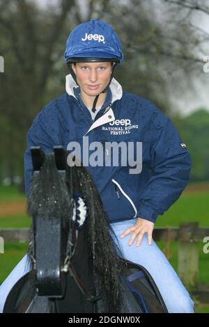 Zara Phillips and a mechanical horse that will give inner city children the chance to feel what its like to ride a horse in Hyde Park In London. Half Length. riding hat.  Stock Photo