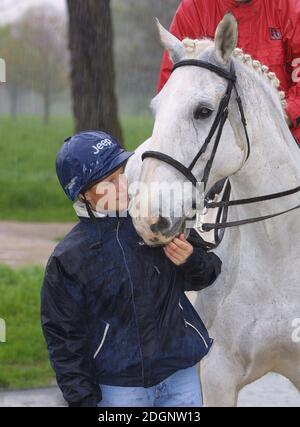 Zara Phillips and a mechanical horse that will give inner city children the chance to feel what its like to ride a horse in Hyde Park In London. Half Length. riding hat.  Stock Photo