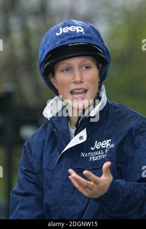 Zara Phillips and a mechanical horse that will give inner city children the chance to feel what its like to ride a horse in Hyde Park In London. Half Length. riding hat. funny  Stock Photo