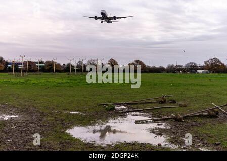 London Heathrow Airport, London, UK. 9th Dec, 2020. Overnight rain has cleared into a cloudy cool morning as the first arrivals land at Heathrow. The rain has left the ground sodden with puddles reflecting the landing aircraft