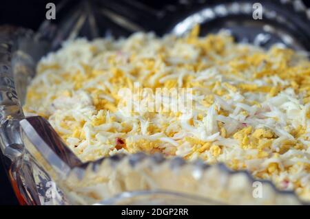 Salad seasoned with mayonnaise and sprinkled with grated cheese. Shallow depth of field Stock Photo