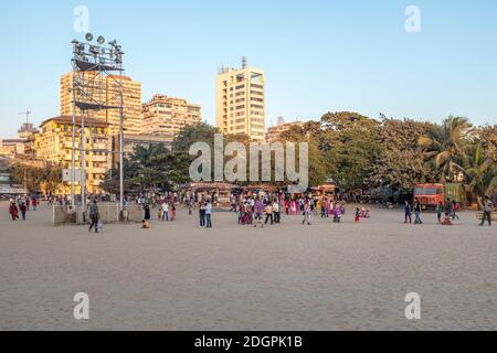 People walking by the street food vendors at Chowpatty beach, South Mumbai, India Stock Photo