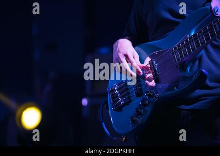 Guitarist bass on stage for background, colorful, soft focus and blur Stock Photo