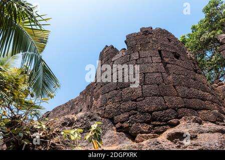 Bottom view of the old stone tower of Portuguese fortress Fort Cabo De Rama in Goa, India Stock Photo