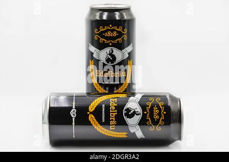 KYIV, UKRAINE - SEPTEMBER 14, 2020: German Edelbrau black beer cans closeup against white background. Stock Photo