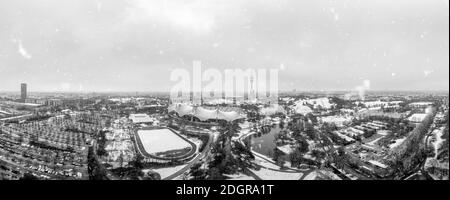 Snowflakes over Munich, the bavarian city in winter with the panoramic view over the Olympic Park, snow covered. Stock Photo