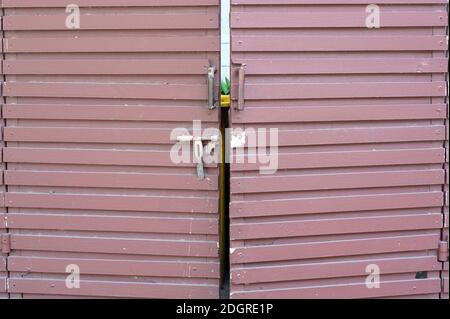 A entry door of a trash storage safety by a hardwood structions. Stock Photo