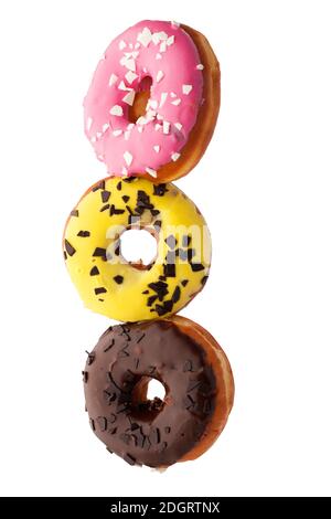 Levitating group of donuts covered with glaze on a white background. Stock Photo