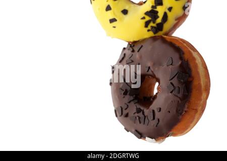 Appetizing levitating chocolate topping donuts isolated on white background. Stock Photo
