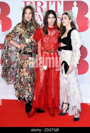 US pop rock band 'Haim', Este Haim, Danielle Haim and Alana Haim attending the Brit Awards at the O2 Arena, London. Photo credit should read: Doug Peters/EMPICS Entertainment Stock Photo