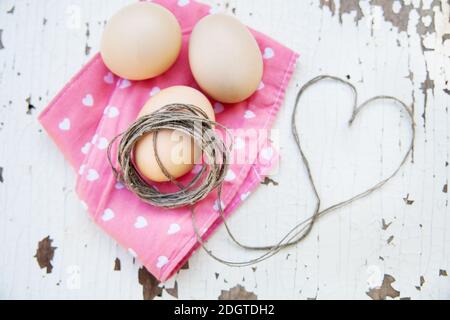 Top view of three eggs on rose napkin. Stock Photo