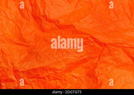 Orange wrinkled paper in a close up view Stock Photo