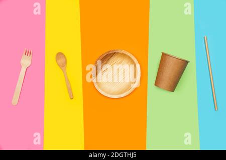 Disposable kitchen utensils on a multicolored background in a top view Stock Photo