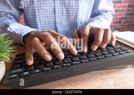 Close up of man hand typing on keyboard  Stock Photo