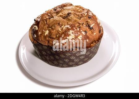 Panettone - Italian Christmas cake from Milan, prepared to celebrate Christmas and New Year, on plate, isolated on white Stock Photo
