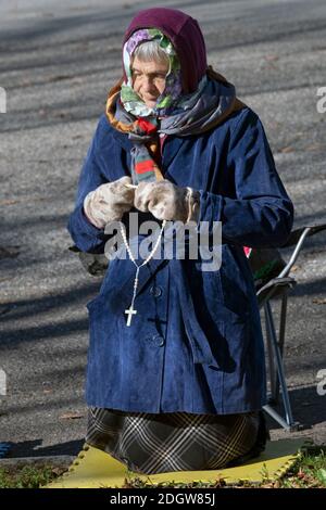 Devout Roman Catholic woman prays at the Vatican Pavilion site in ...