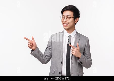 Waist-up portrait of successful, professional young asian man starting his career in IT company, presenting his project on meeti Stock Photo