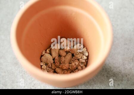 Little stones in a clay pot Stock Photo