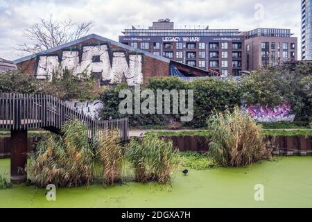 London, Newham, Stratford. Lea river. Derelict warehousing, brownfield land, Legacy wharf development around Lea River canal. Polluted, stagnant water Stock Photo