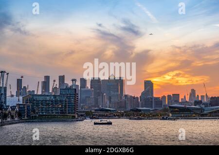 London, Newham, Royal Victoria Docks, skyline of Docklands financial district, O2 arena, commercial buildings, sunset Stock Photo