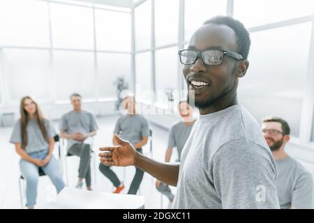 rear view. smiling business coach standing in the conference ro Stock Photo