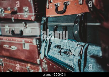 Stack of old suitcases that have seen a lot of traveling. retro luggage. Lots of vintage leather suitcases Stock Photo