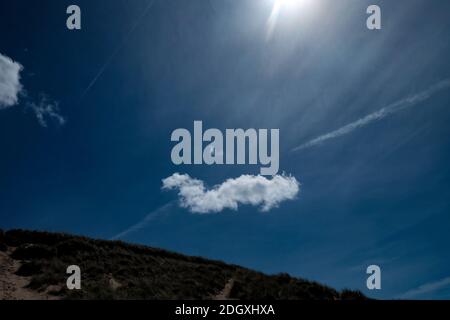 Defined single white cloud on a deep blue sky Stock Photo