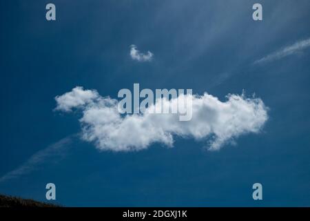 Defined single white cloud on a deep blue sky Stock Photo
