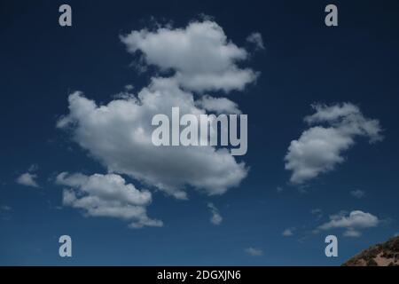 Defined white clouds on a deep blue sky Stock Photo