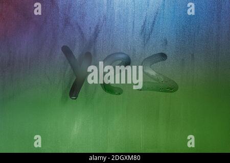 word yes handwritten on foggy window glass surface Stock Photo