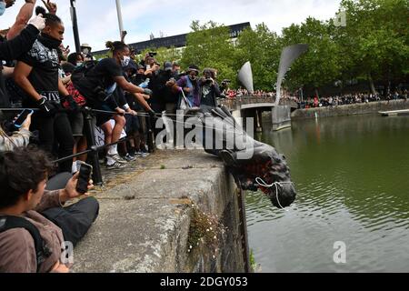 File photo dated 07/06/20 of protesters throwing a statue of Edward Colston into Bristol harbour during a Black Lives Matter protest rally. Four people have been charged with criminal damage over the toppling of the statue of Edward Colston in Bristol in June, the Crown Prosecution Service has said. Stock Photo