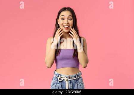 Surprised happy young b-day girl open eyes and see awesome gift friends made, looking camera asonished and cheerful, cant believ Stock Photo