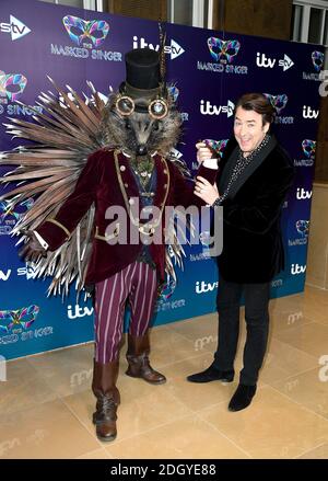 Jonathan Ross (right) with a person dressed as a Hedgehog attending The Masked Singer press launch at The Mayfair Hotel, London Stock Photo