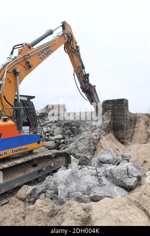 Sellin, Germany. 09th Dec, 2020. On the steep coast of Sellin on Rügen an excavator is busy demolishing an old NVA bunker. The 300 square metre GDR bunker made of one metre wide concrete walls had been built in 1959. Until 1988 it had been part of the Technical Brigade Coast on the island of Rügen and was part of the radio and airspace surveillance in the Baltic Sea area. The cost of the demolition work is currently estimated at around 120 000 euros. Credit: Stefan Sauer/dpa-Zentralbild/dpa/Alamy Live News Stock Photo